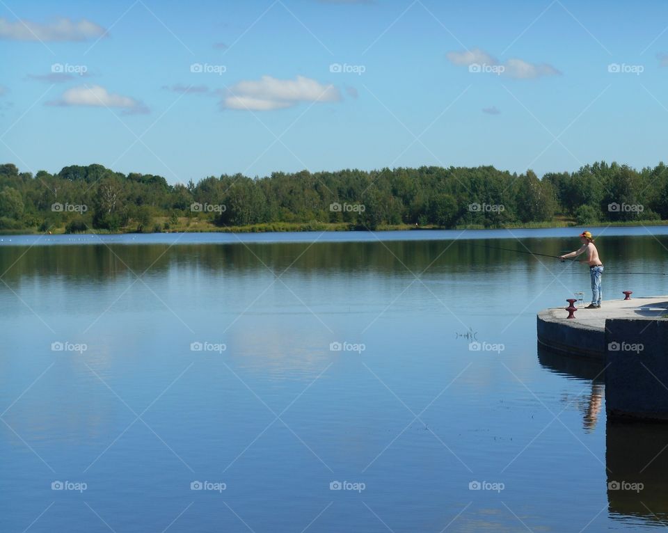 men fishing on a lake beautiful nature landscape blue sky background