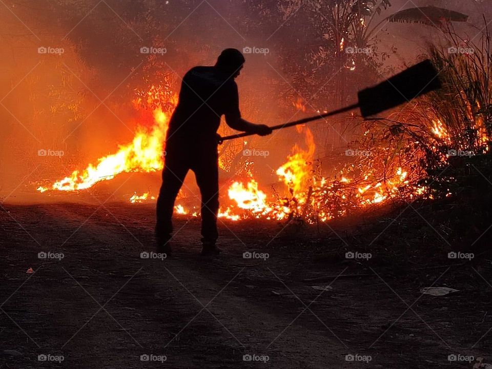 Fireman fighting fire in the jungle 