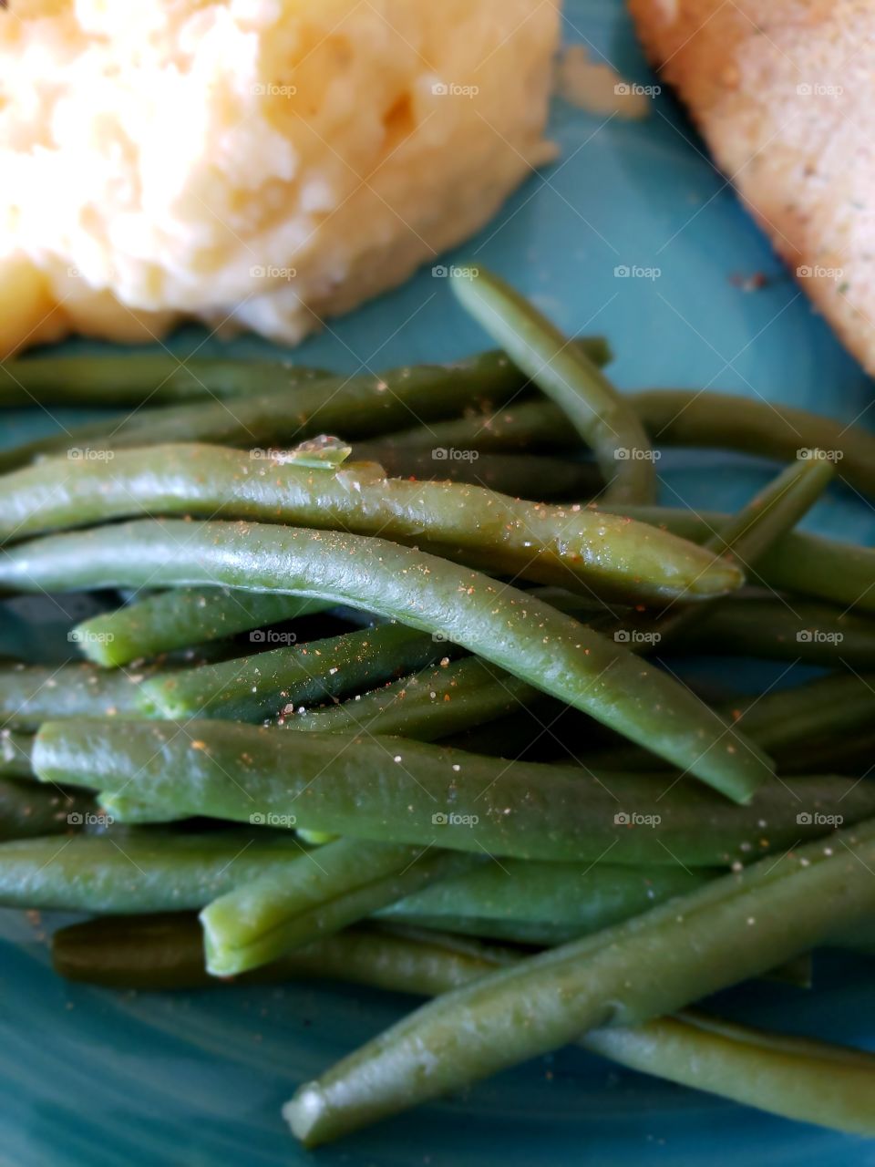 A delectable serving of freshly steamed green beans with delicious seasoning.
