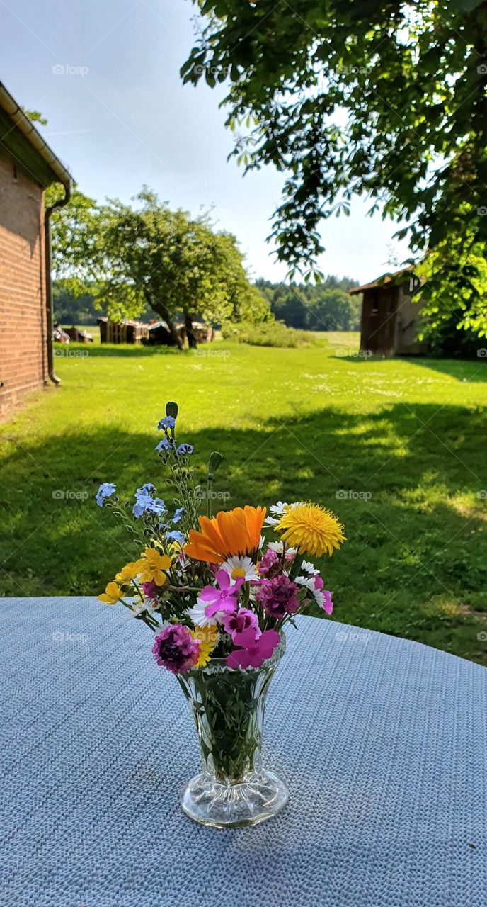 Flowers in a Vase - bouquet of wild flowers on the garden  table in the great outdoors