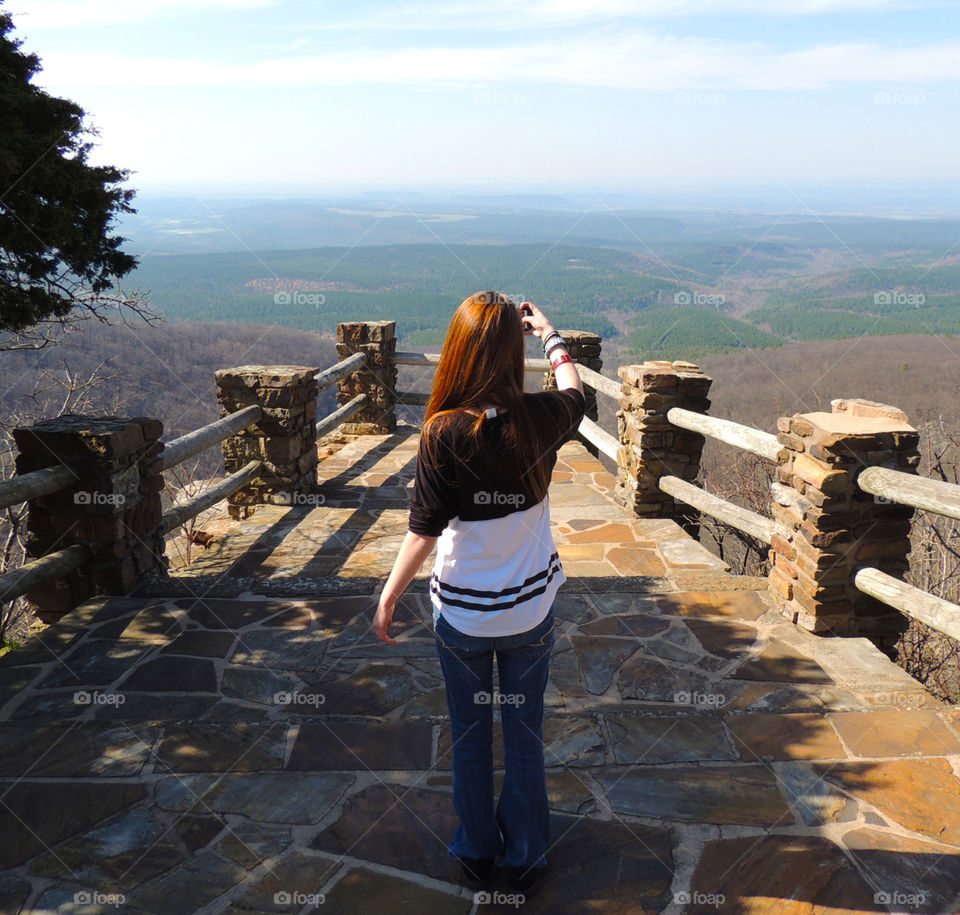 Girl photographing scenic overlook mountain landscape view