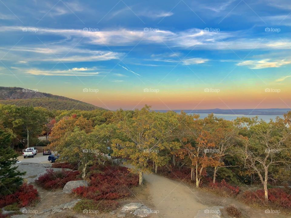 Scenic landscape and ocean view with colorful sunset from the peak of Mount Battie in Camden, Maine during late Autumn. 