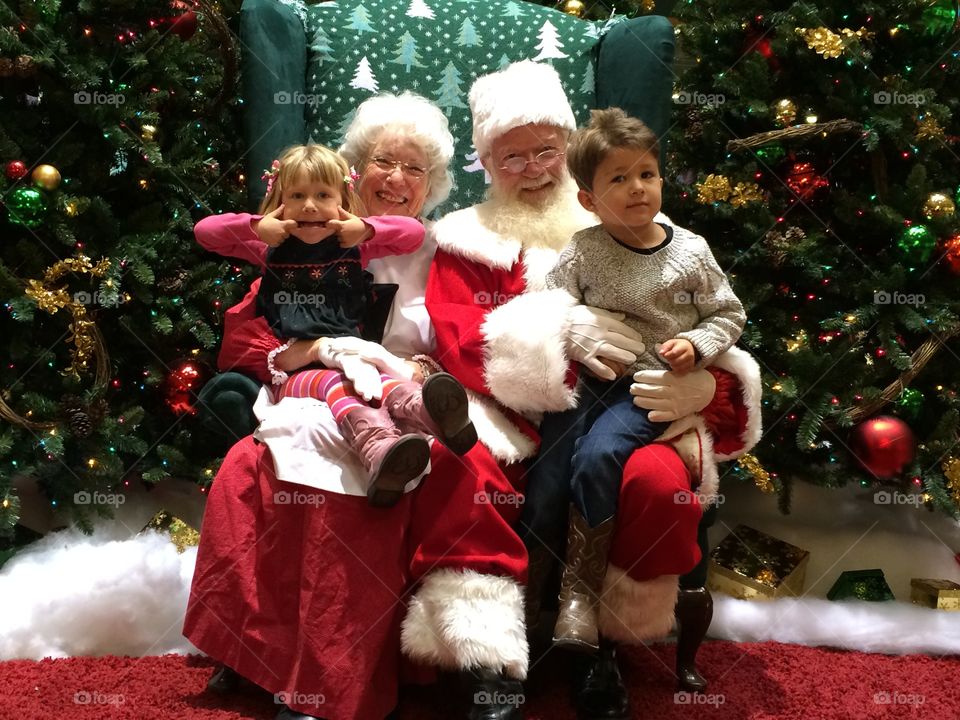 Naughty and Nice. Siblings taking their photo with Santa. One is a spitfire if you can't tell.