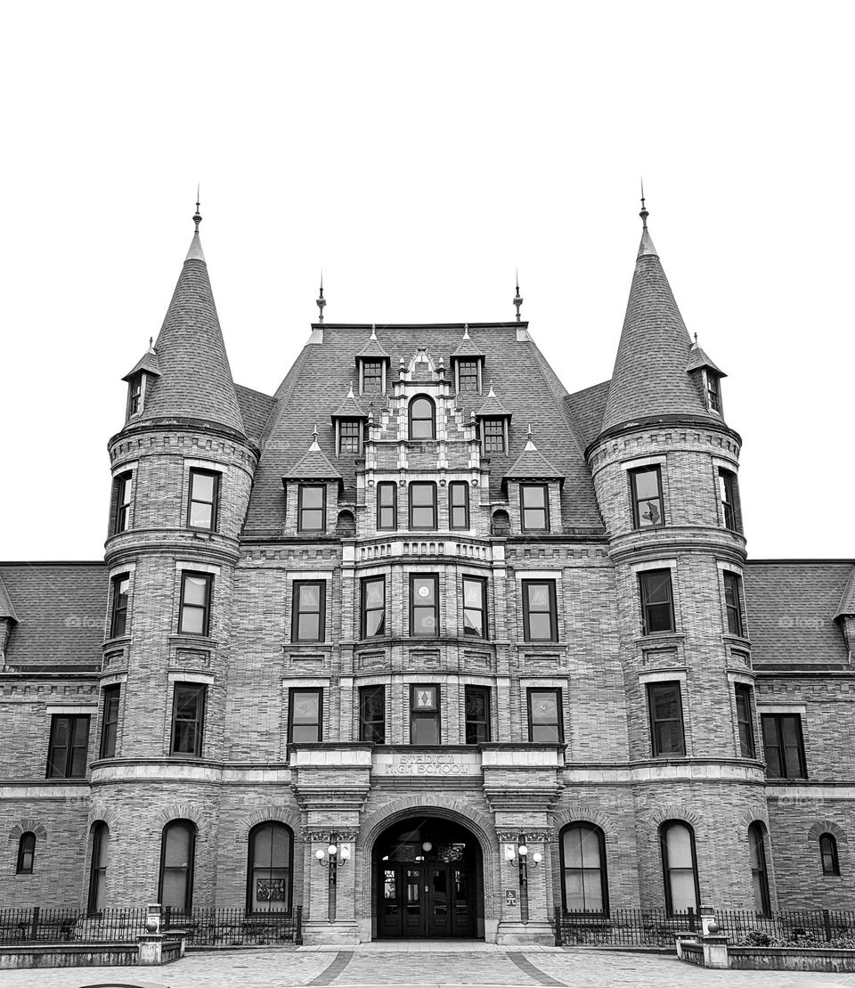 castle style architecture with brick walls and cone shape roof