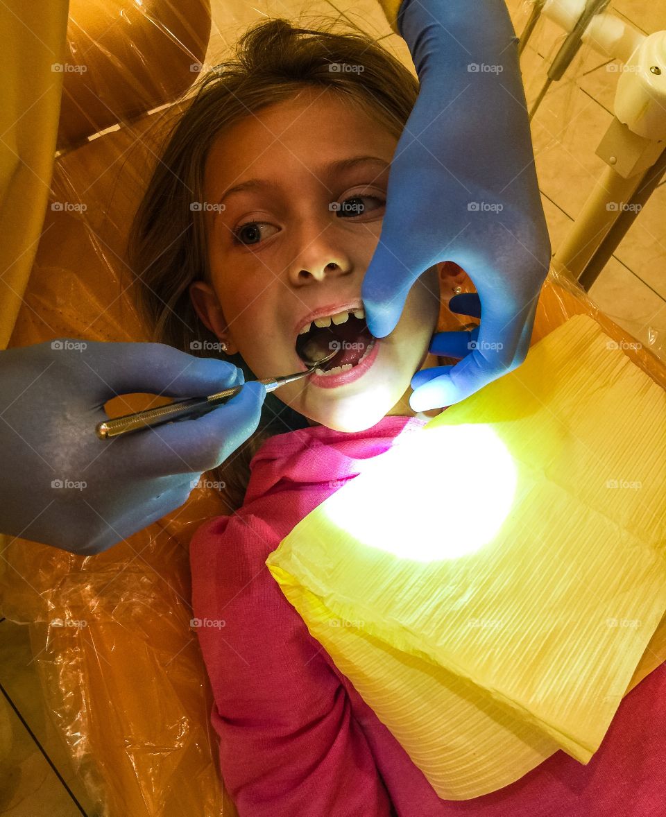 Close-up of girl with open mouth at dentist