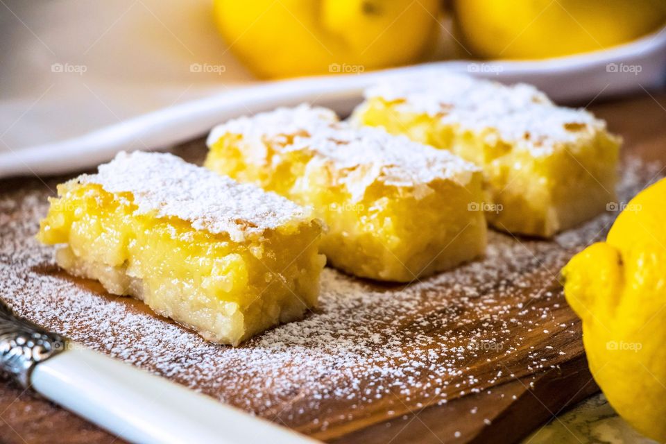 Lemon custard bars with icing sugar sprinkled on top.
