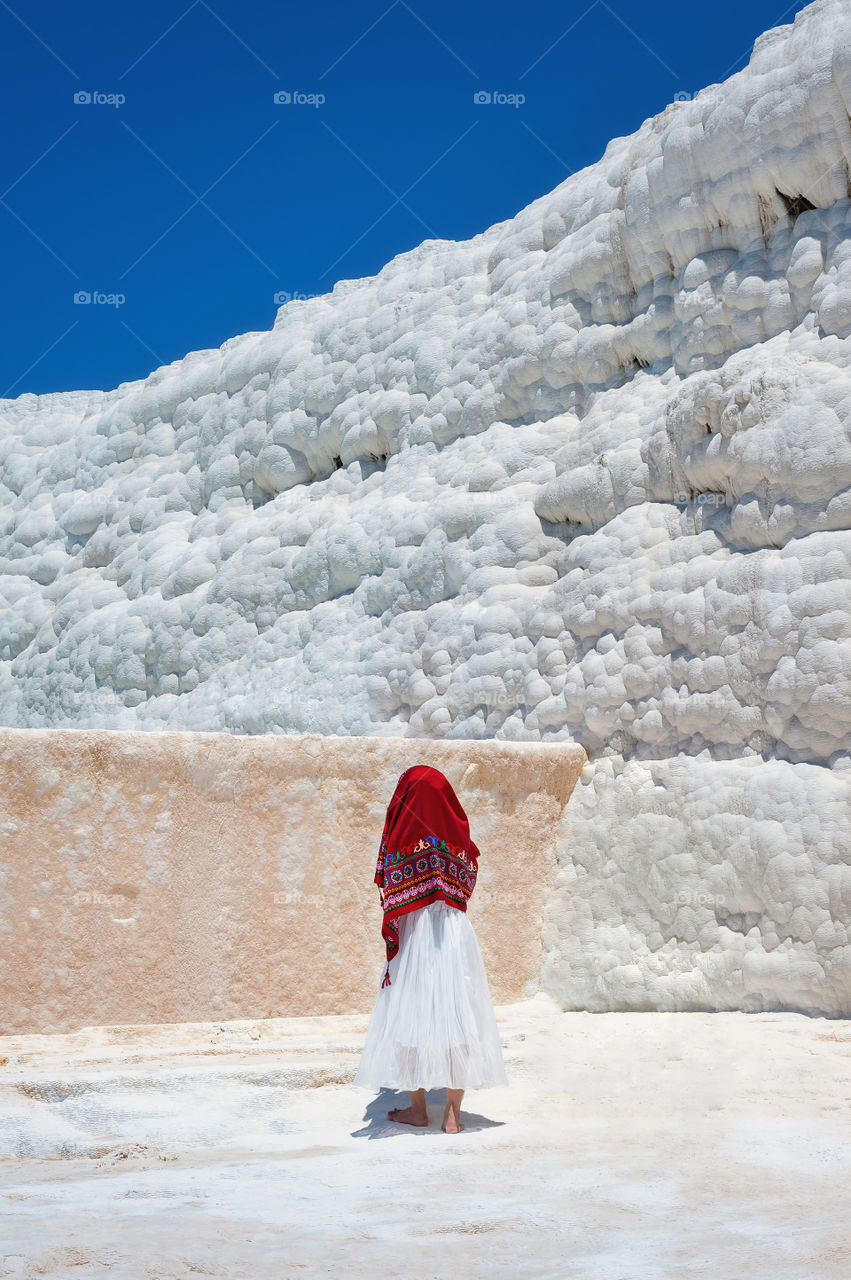 Girl with red headscarf. Pamukkale Travertines, known as the Cotton Castle. Turkey.