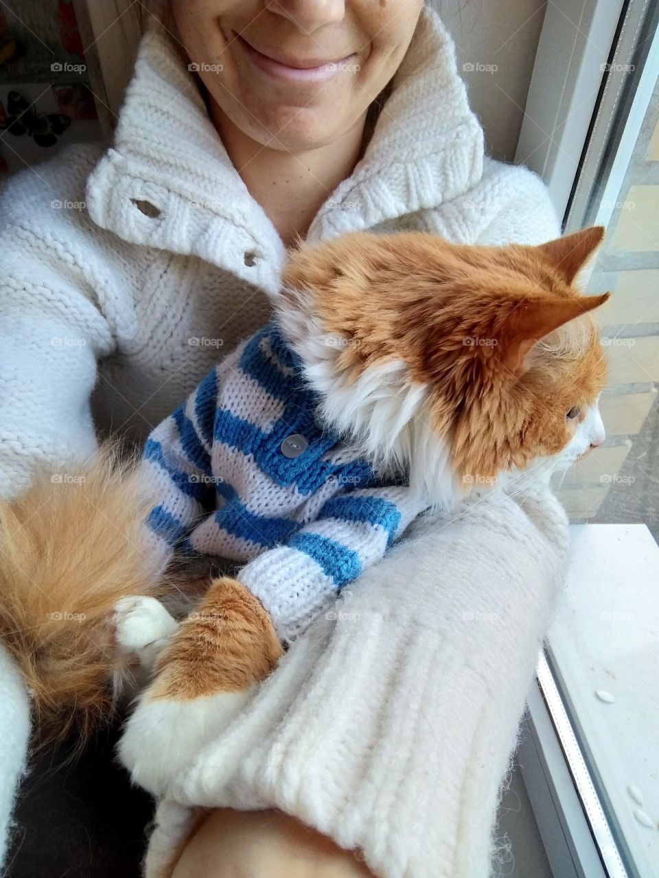 selfie girl with cat pet in the sweater