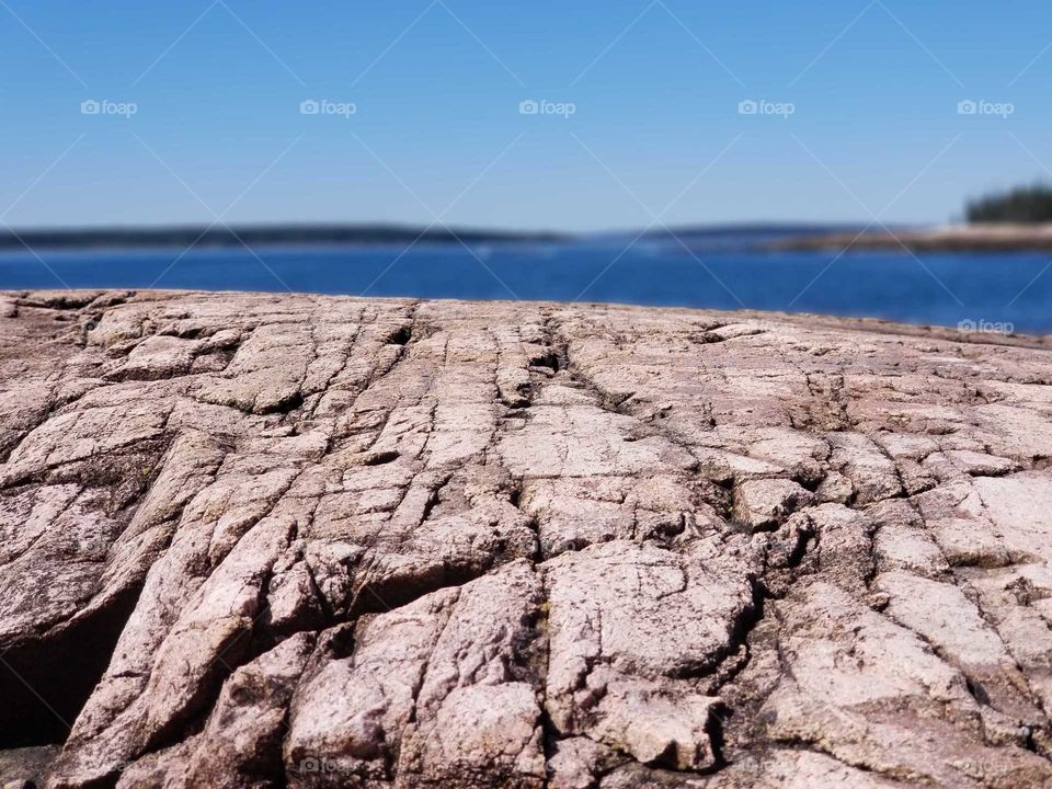 Cracked rock with water on the background