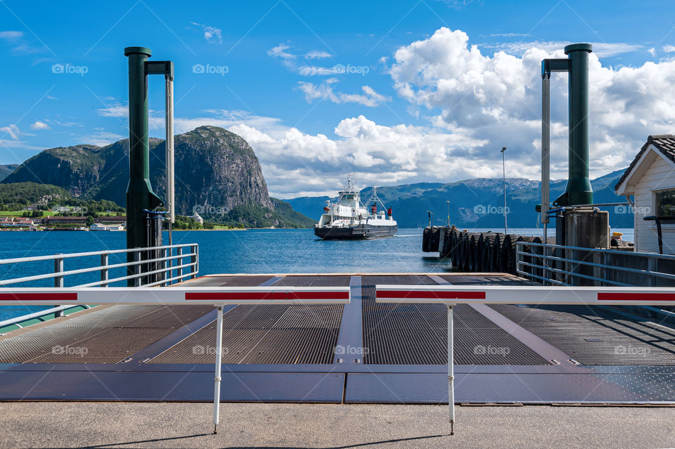 Fjord ferry approaching harbor.