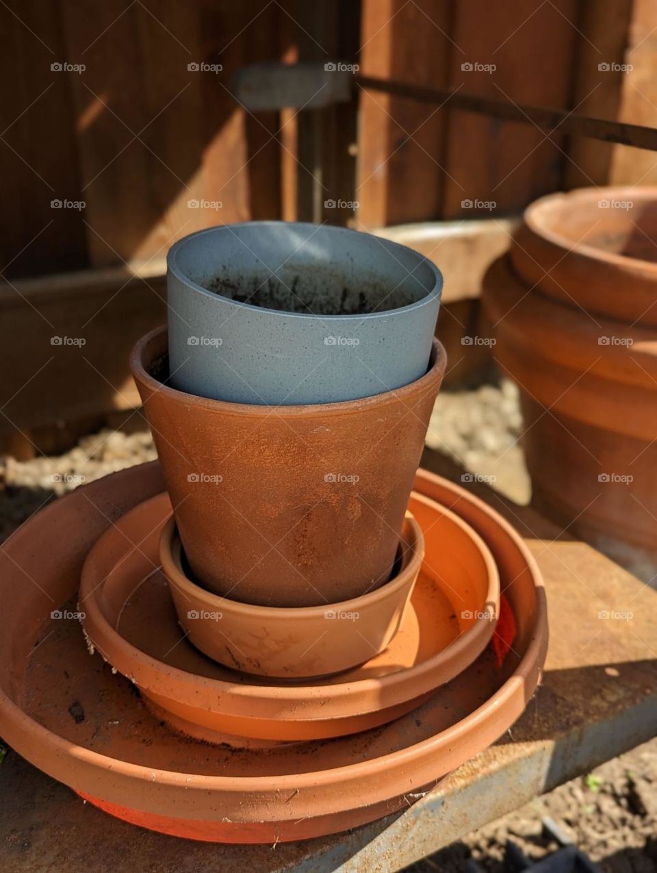 Empty terracotta plant pots waiting to be potted at my upcycled potting table outdoor pots spring and summer planting garden table shed