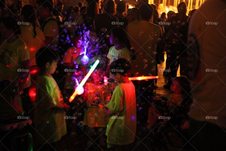 Kids playing in new year eve party with neon lights 