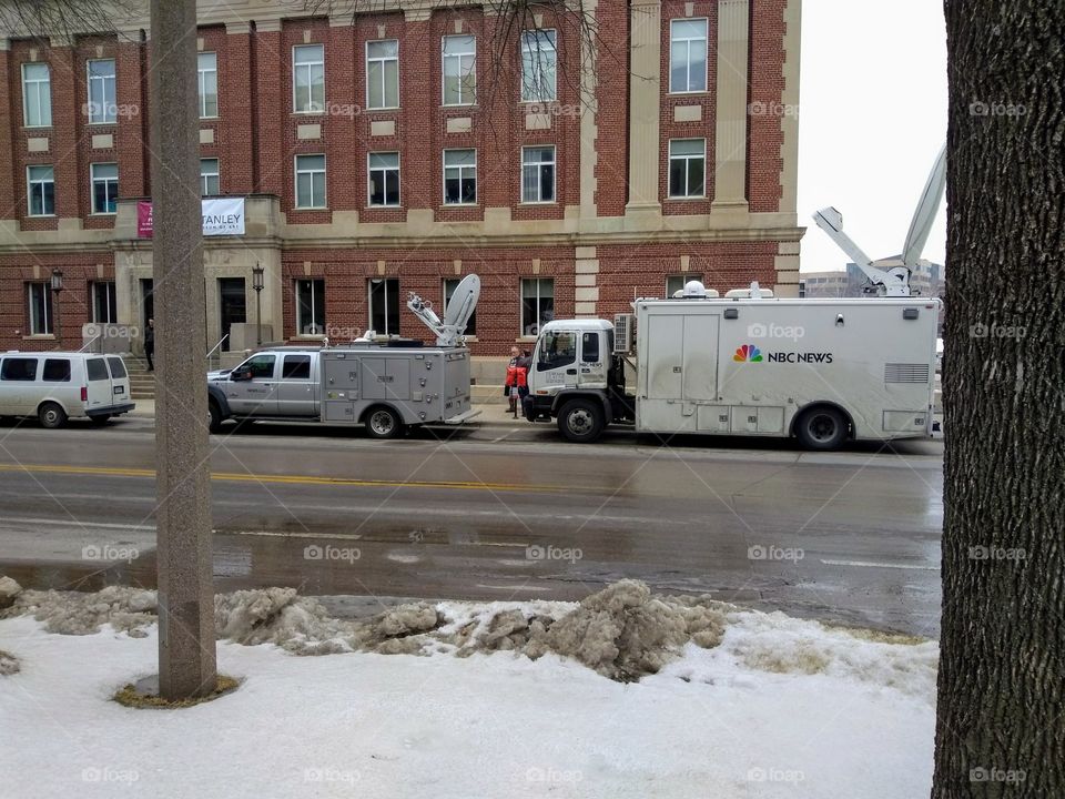 news media vans outside Iowa Memorial Union