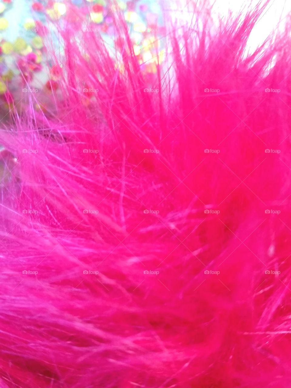 pink fluff ball with glitter in background