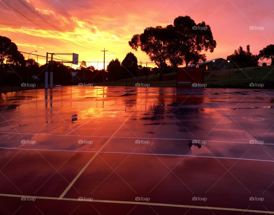 Basketball court after rain during sunset