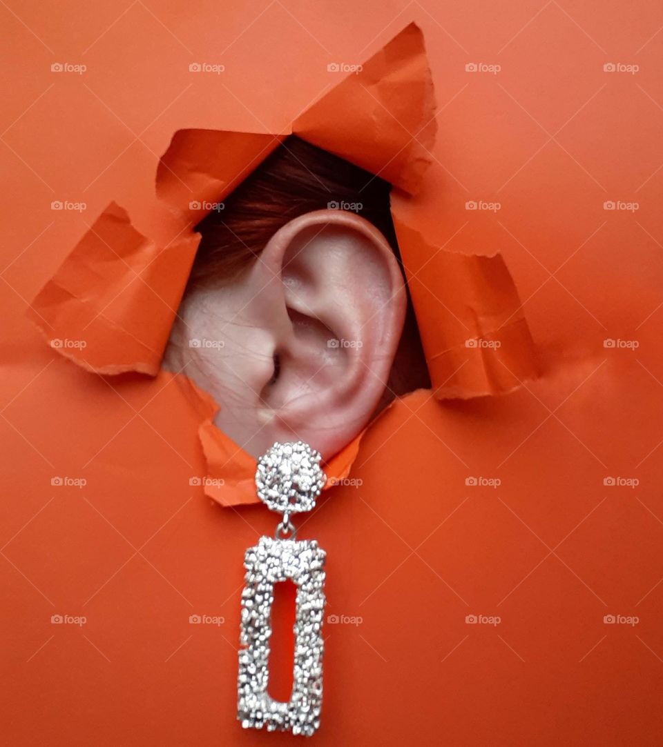 Silver earrings on the ear