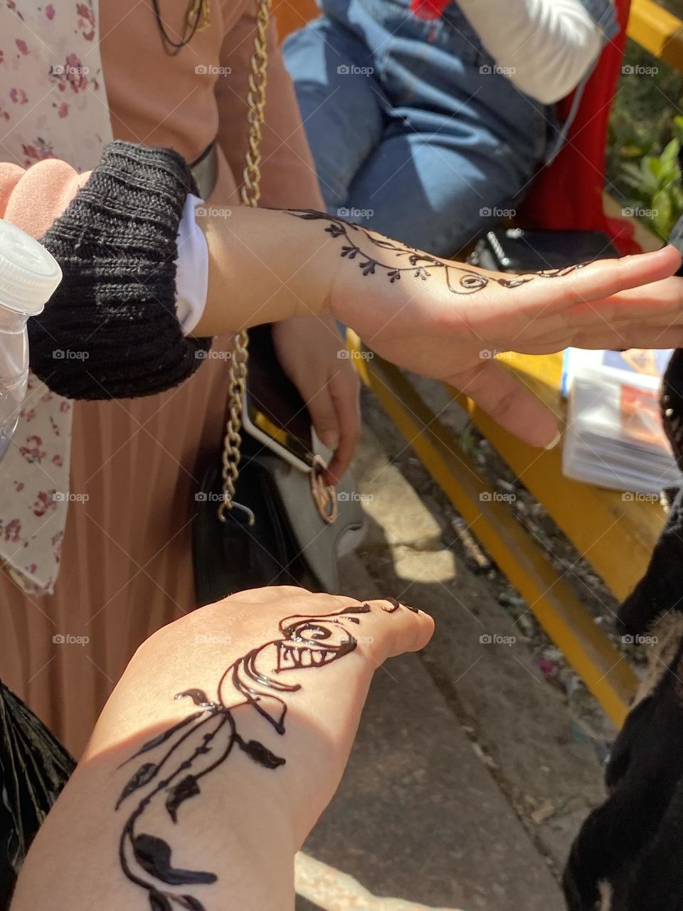 Painting henna on hands