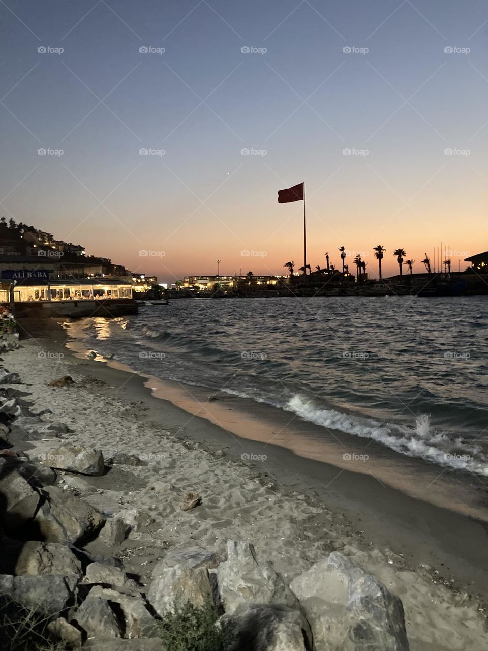 Beach time on holidays. Blue sky and tall palm trees. Sunsets and sunny days. Summertime in Kusadasi. Vacation travel in Turkey . Summer view. Sunny day during vacation 