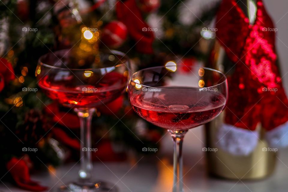 Two glasses with pink champagne to celebrate winter