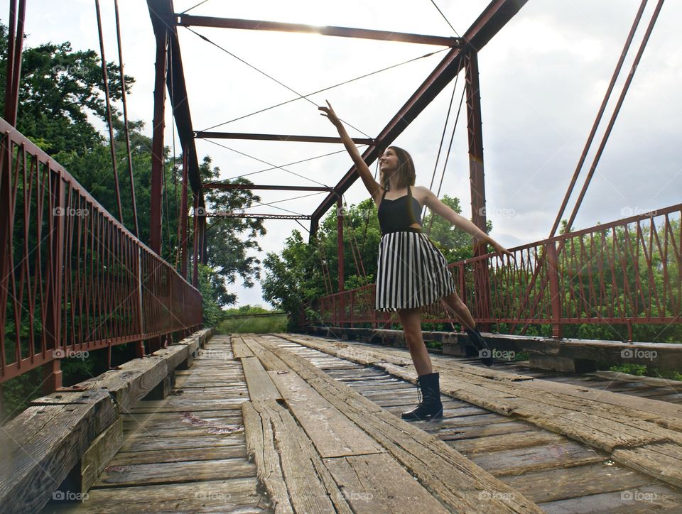 Dance love. Teen girl dancing on a bridge 