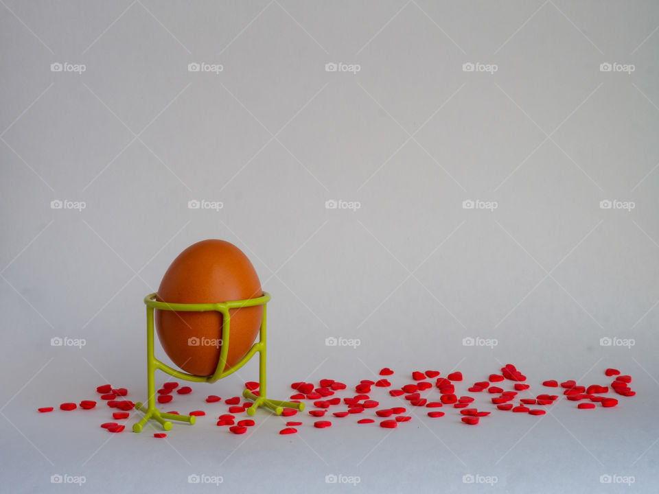 Brown egg of light color prepares for the holiday Easter on a white background
