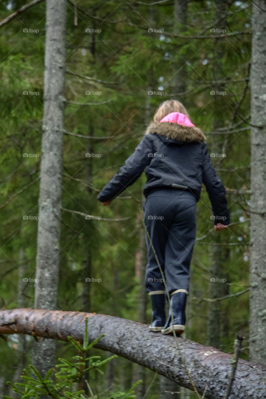 Girl balances in a tree stock