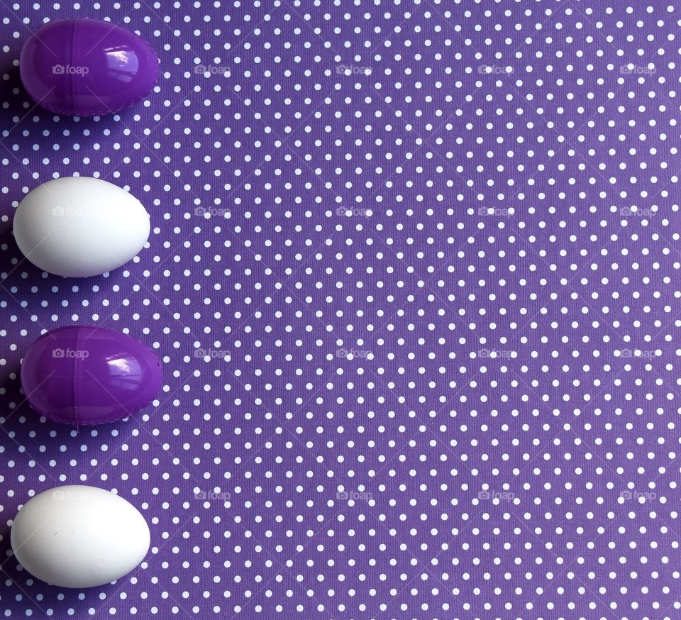 Purple and white polka dot background with purple and white eggs 