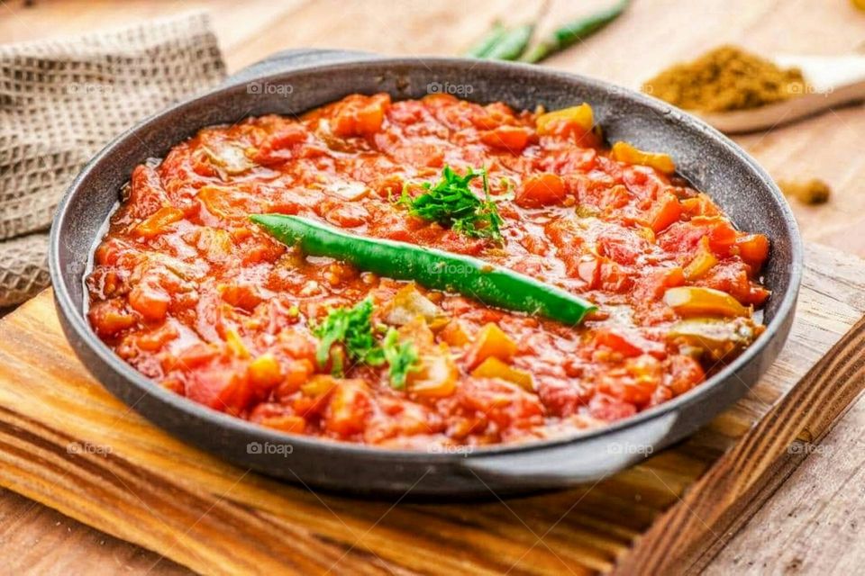 Tomato frying pan with hot pepper for lunch