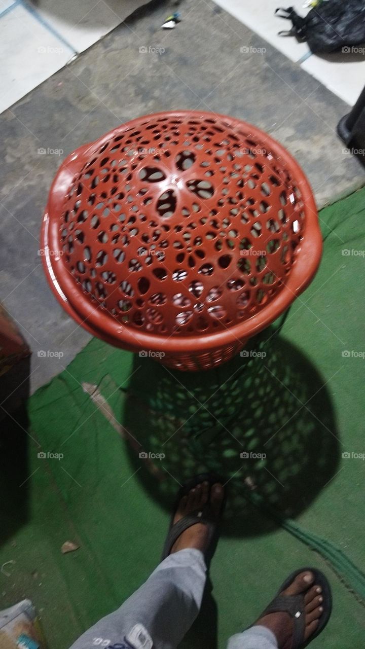 red perforated laundry bucket