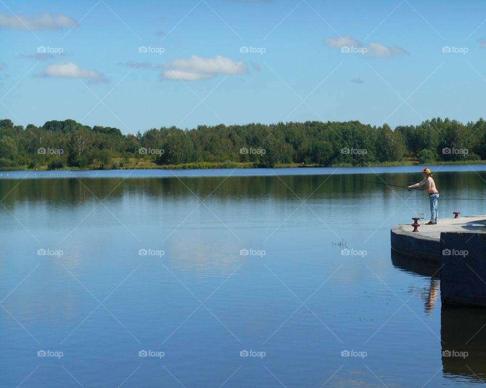 man fishing on a lake summer landscape