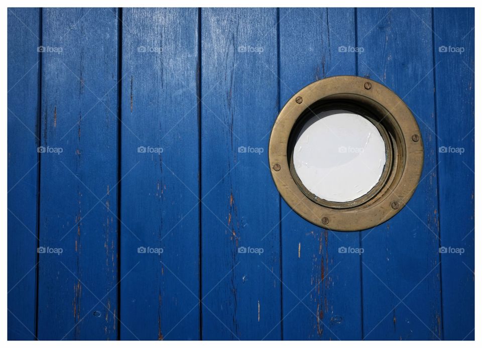 Detail of blue sea cabin with porthole