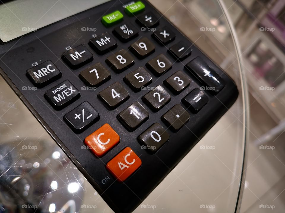 Calculator on a glass table