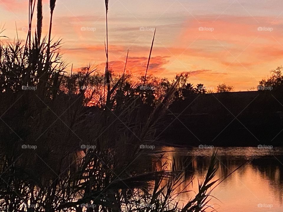 Lake bed grass shadows and clouds on lake waters evening Colours trying to work along with Twilight