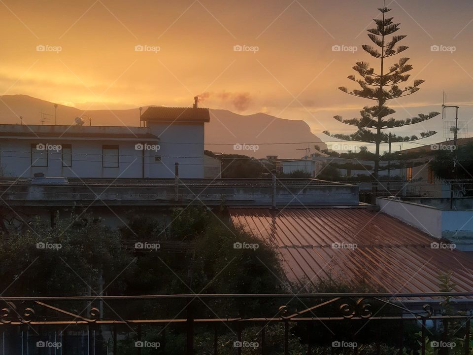 sunset with tree and mountain