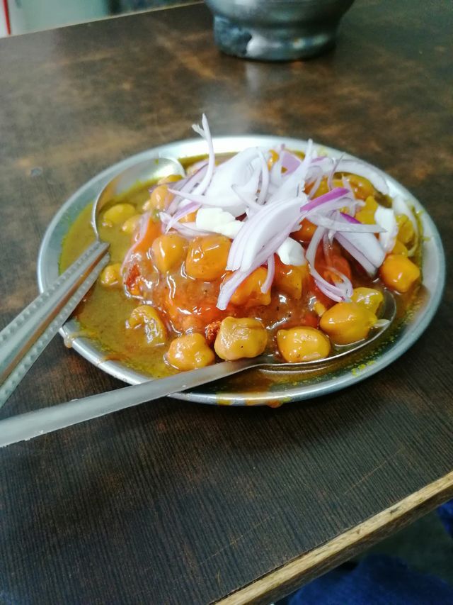 Chickpeas Masala or Chole Masala tradional North Indian lunch, dinner menu served in a plate. Famous Street Food in India.