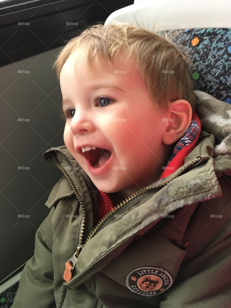 A very happy boy on his first big boy bus ride. 