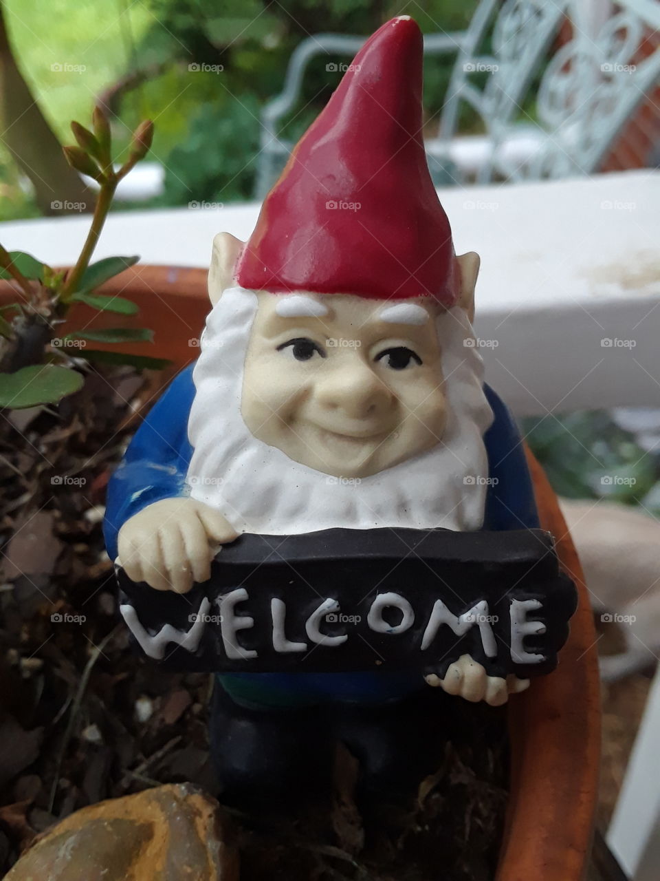 tiny garden gnome with welcome sigh