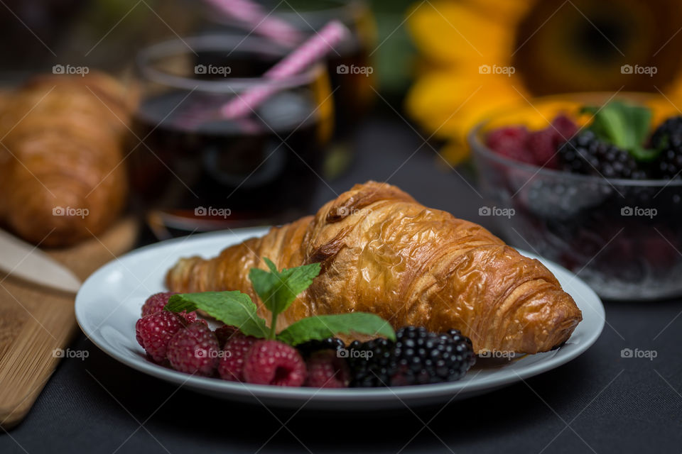 Croissant with fruit served in plate