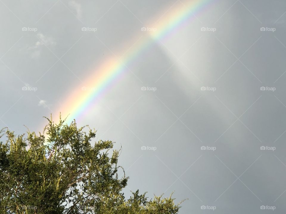 Evening rainbow with sweeping storm clouds