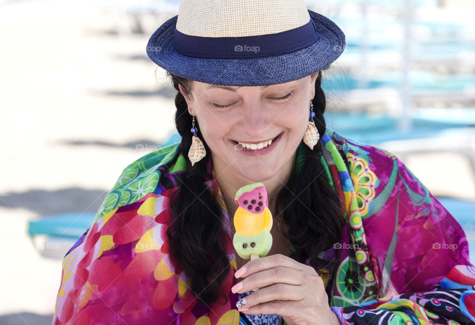 Summer mood, colorful portrait of smiling woman holds an ice cream