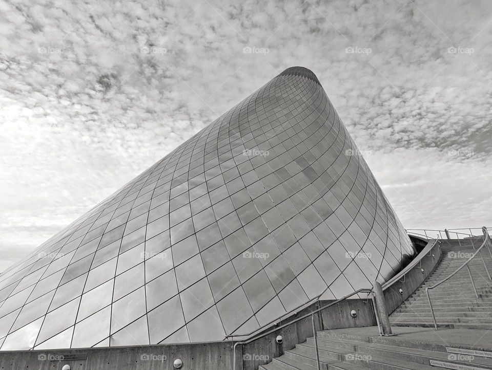 metal cone shape structure with diamond tile cover next to stairs