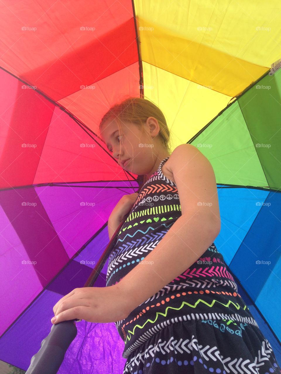 Rainbow of protection. Girl under rainbow umbrella