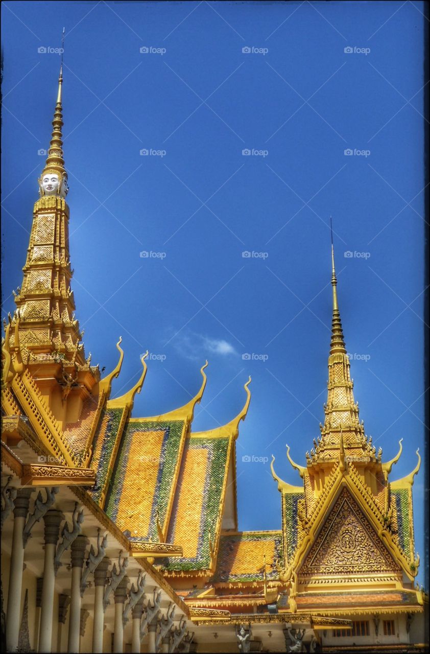 The Royal Palace In Phnom Penh - gold roofs and blue sky...
