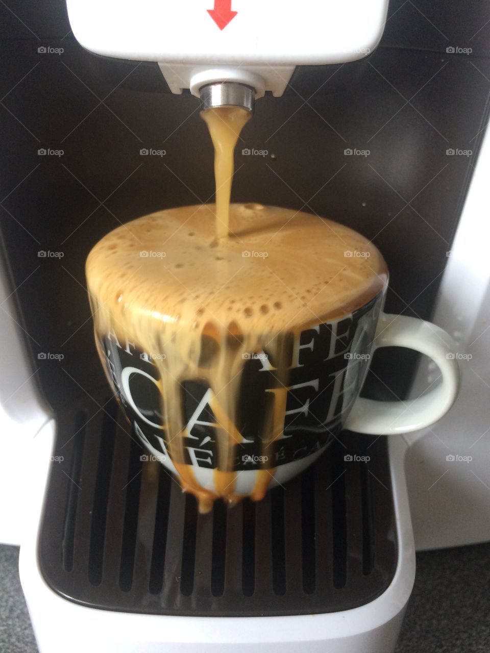 Overflowing espresso coffee cup