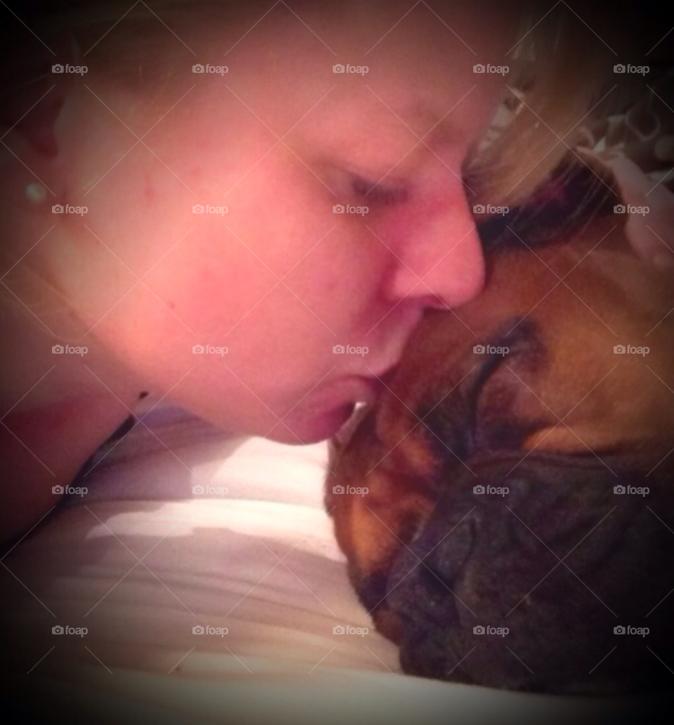 Close-up of woman kissing her dog