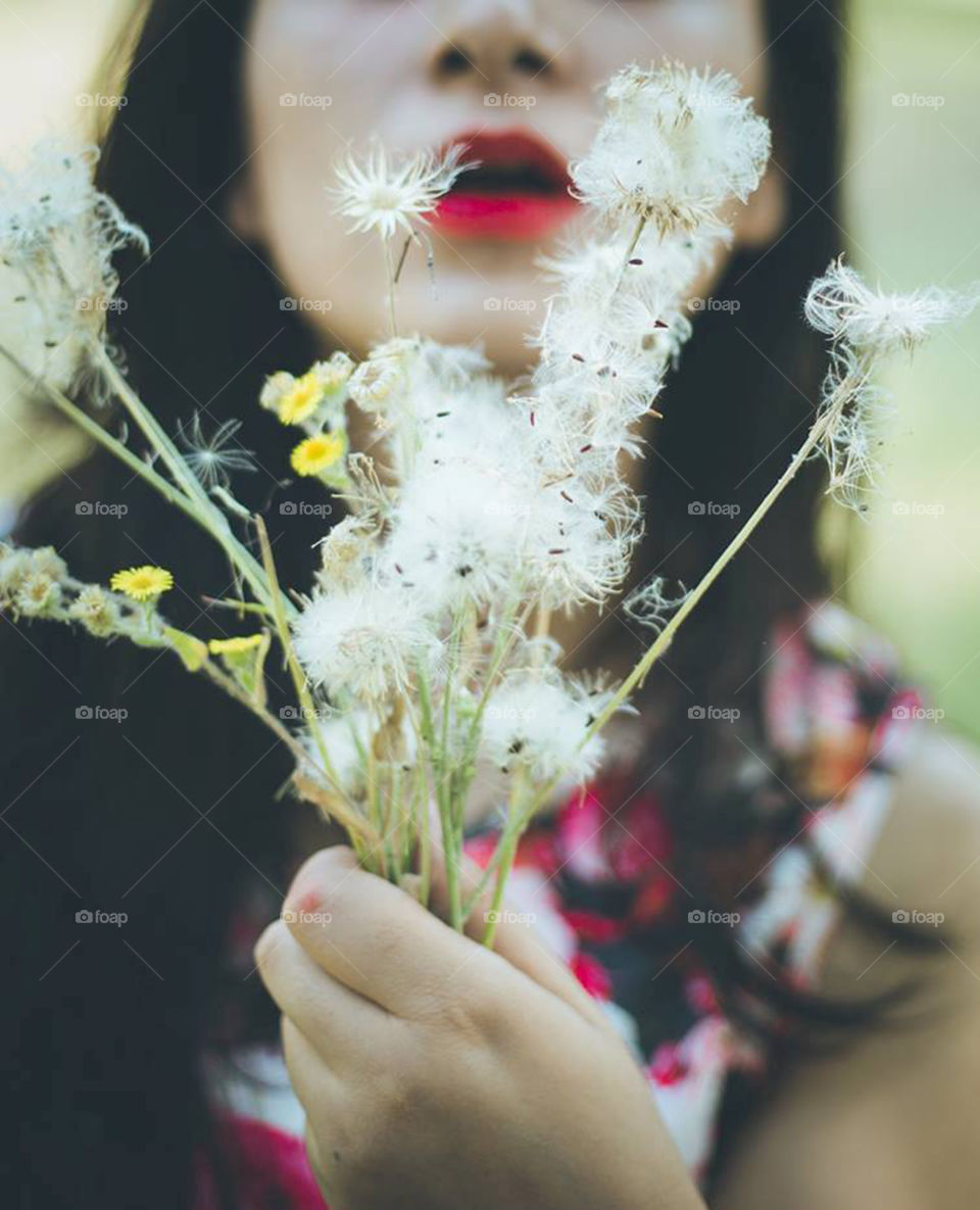 Close-up of hand holding flowers