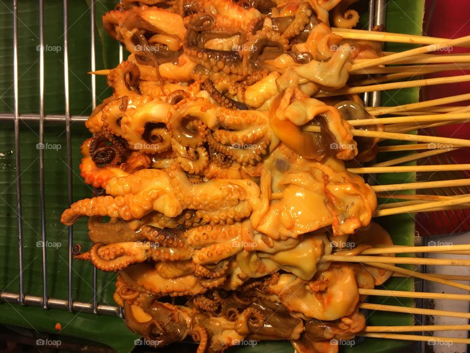 Delicious squids on sticks in night market