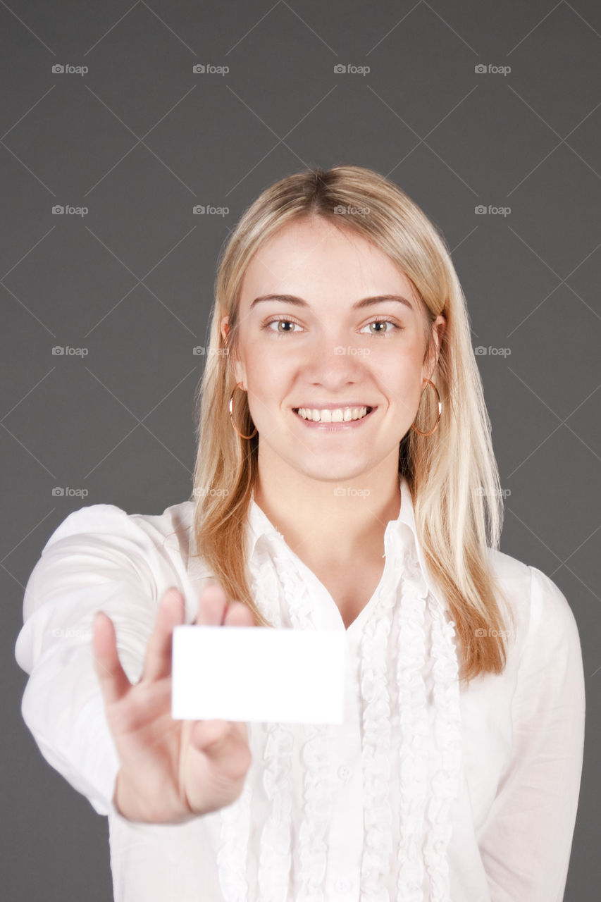 The business lady stretches a white card