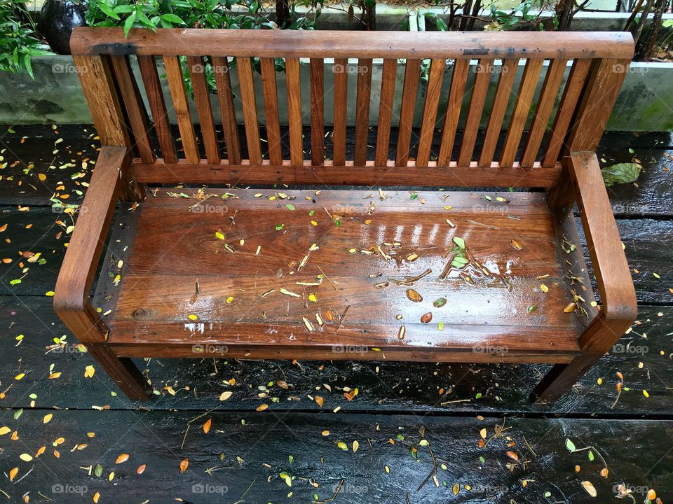 Wet chair on wood in garden 