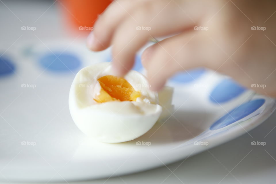 Childrens hand reaching for an egg